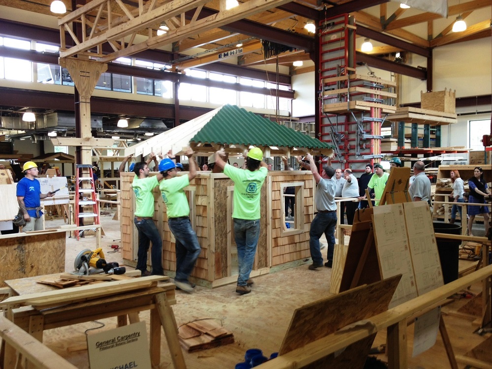 A storybook house, built by 4th year trainees at the Carpenters Training Center. It's the centerpiece of the Bookworm Glen in the Eastern European Woodlands.