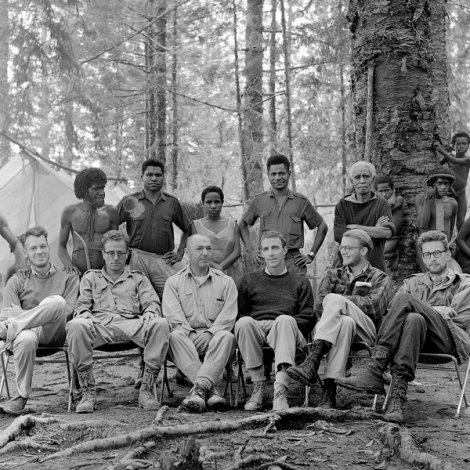 Peter Matthiessen (dark crewneck sweater front row) with Michael Rockefeller in New Guinea. Photo by Eliot Elissofon, courtesy of Harvard Peabody Museum.