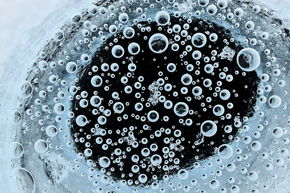 Greenland Ice Sheet, July 2008. Air bubbles possibly up to 15,000 years old, are released as ice sheet melts. From ICE: Portrait of the World's Vanishing Glaciers. (Copyright EIS/James Balog)