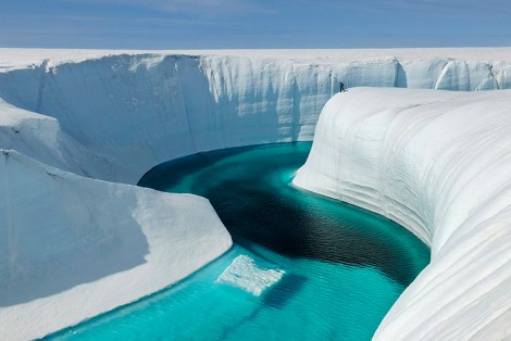 Greenland Ice Sheet 2009. Adam LeWinter surveys Birthday Canyon. From ICE:Portraits of the World's Vanishing Glaciers . (Copyright EIS/James Balog)