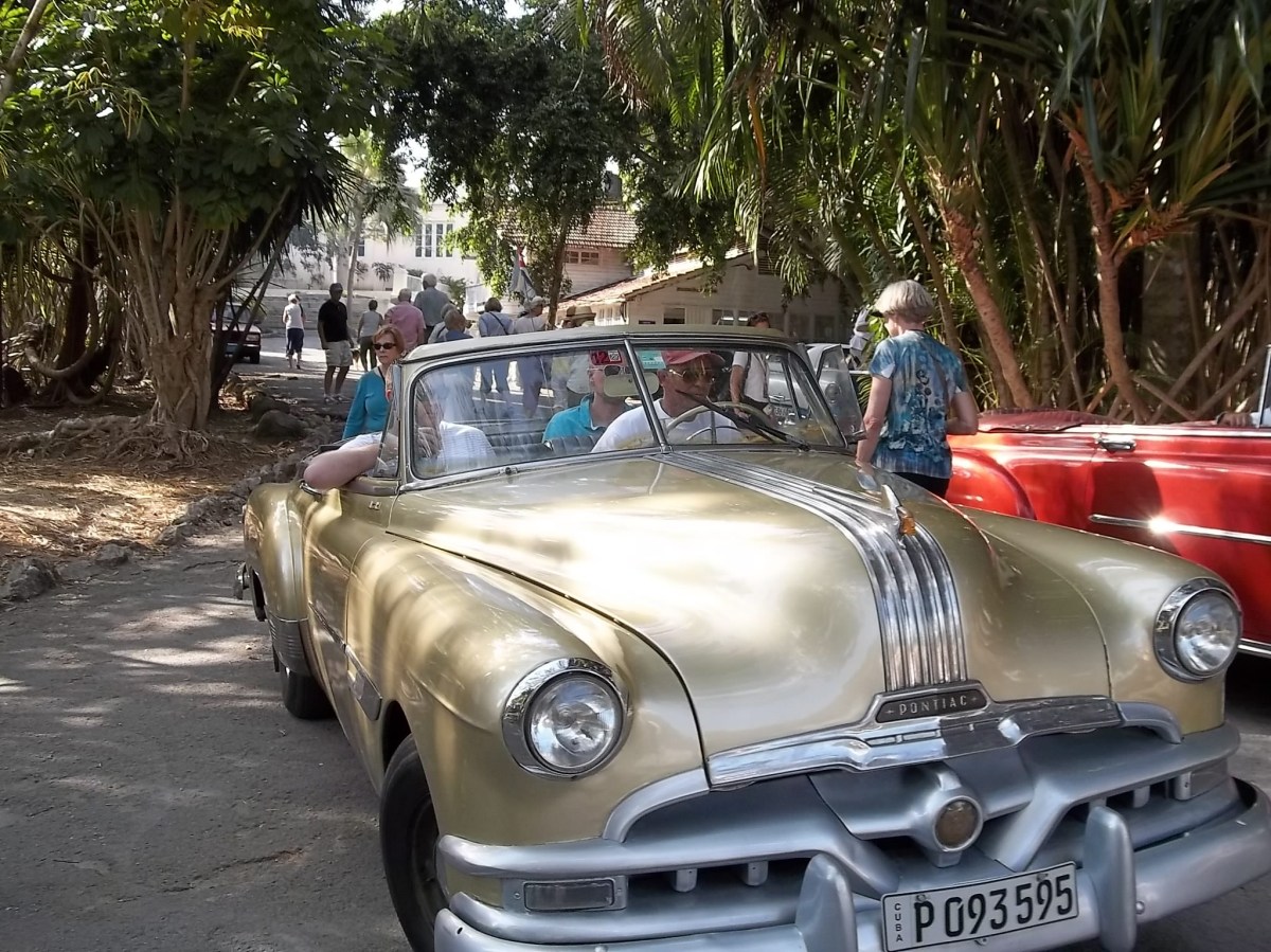 Out for a spin in a restored Pontiac. Tourists and visitors love to see the vintage American cars lovingly maintained. For Cubanos, it's a necessity!