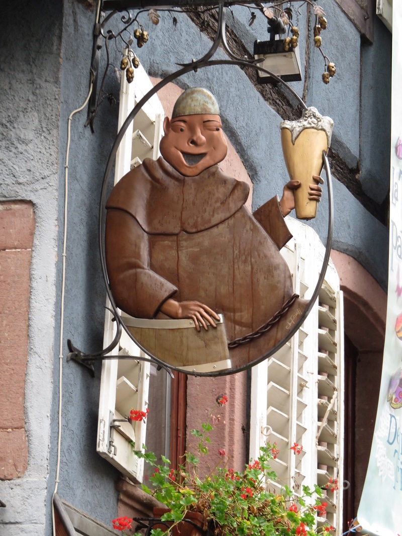 A Benedictine brother hoists a glass for the holidays in Alsace (France)> (Bobbie Faul-Zeitler, CC 3.0)
