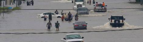 People walk through flood waters of West Houston on Sunday August 27, 2017. Thomas B. Shea Getty Images