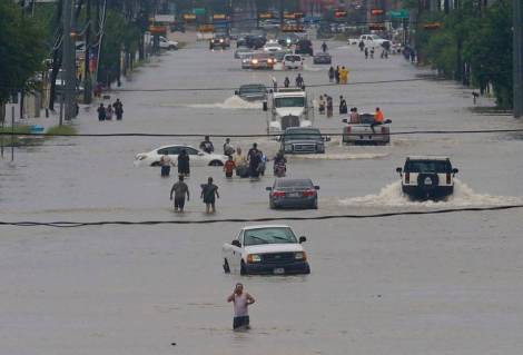People walk through flood waters of West Houston on Sunday August 27, 2017. Thomas B. Shea Getty Images
