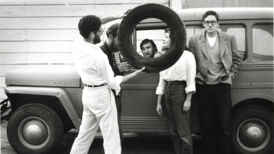 Walter Hopps (in glasses) with freidns at the Ferus Gallery. Photo by Brittin